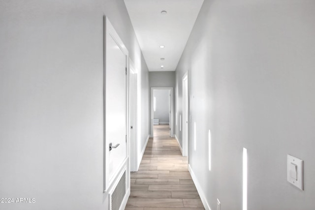 hall with light hardwood / wood-style floors