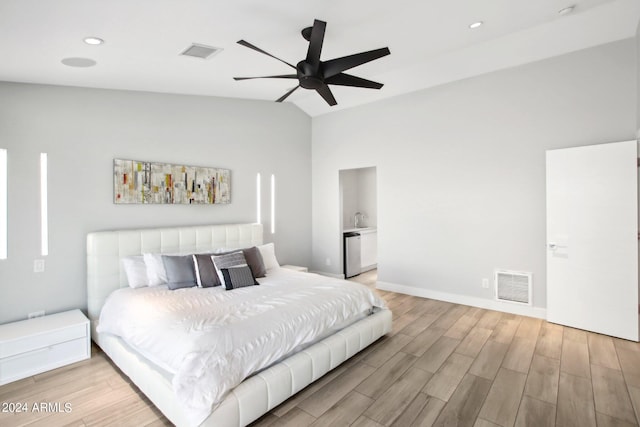 bedroom with light hardwood / wood-style flooring, lofted ceiling, and ceiling fan