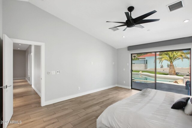 bedroom featuring light hardwood / wood-style floors, access to outside, lofted ceiling, and ceiling fan