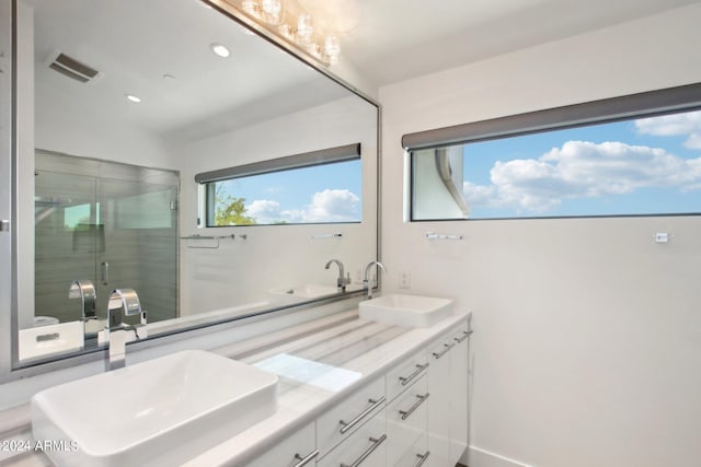 bathroom with vanity, lofted ceiling, and an enclosed shower