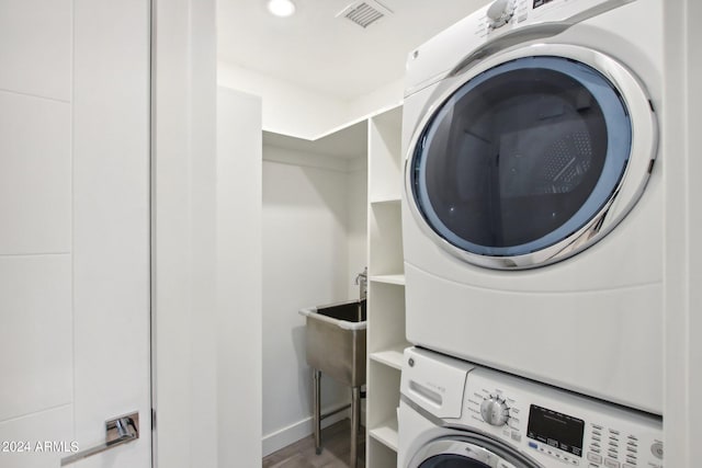 laundry room featuring stacked washer and clothes dryer