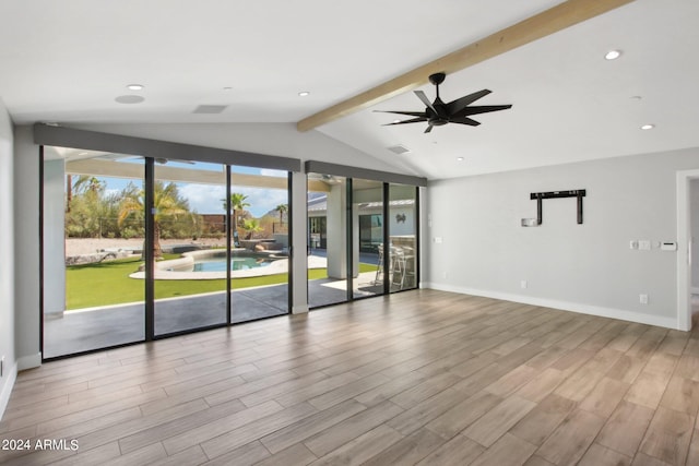 spare room featuring ceiling fan, lofted ceiling with beams, and light wood-type flooring