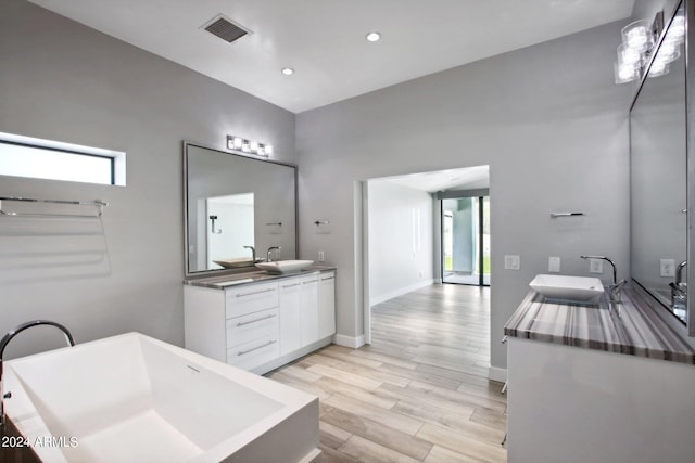 bathroom with vanity and hardwood / wood-style flooring