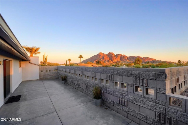 patio terrace at dusk with a mountain view