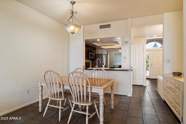 4015 N 78th St Unit 135, Scottsdale, AZ 85251 - dining space featuring a raised ceiling, recessed lighting, and stone tile floors
