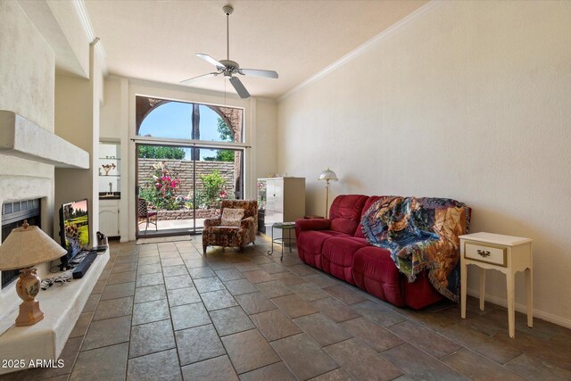 4015 N 78th St Unit 135, Scottsdale, AZ 85251 - living area featuring a ceiling fan, a fireplace with raised hearth, stone tile flooring, and ornamental molding