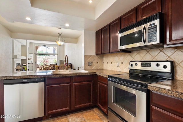 4015 N 78th St Unit 135, Scottsdale, AZ 85251 - kitchen with appliances with stainless steel finishes, tile counters, tasteful backsplash, recessed lighting, and hanging light fixtures