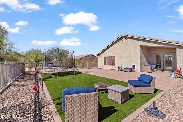 4657 E Matt Dillon Trl, Cave Creek, AZ 85331 - view of yard with a trampoline, a patio area, french doors, and an outdoor fire pit