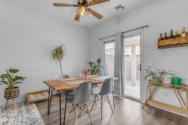 dining room with ceiling fan and hardwood / wood-style flooring