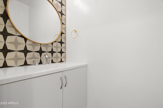 bathroom featuring vanity and backsplash