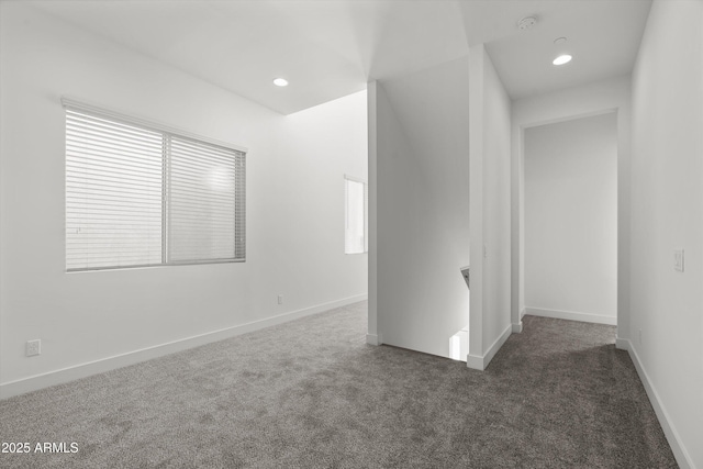 unfurnished room featuring dark colored carpet