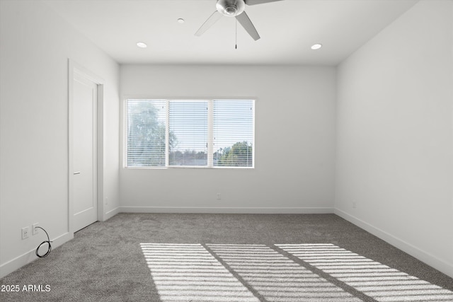 carpeted spare room with ceiling fan