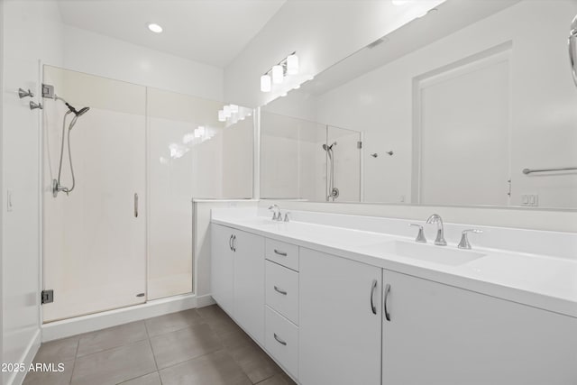 bathroom with walk in shower, vanity, and tile patterned flooring