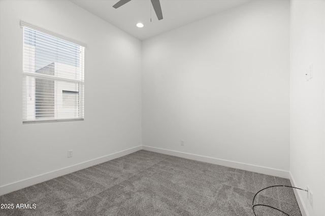 carpeted spare room with ceiling fan