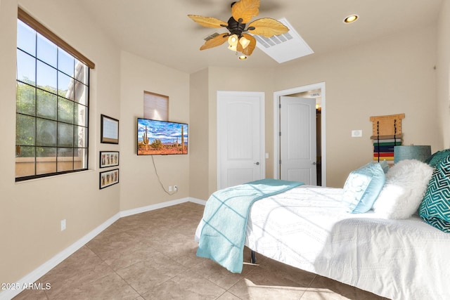 tiled bedroom featuring ceiling fan