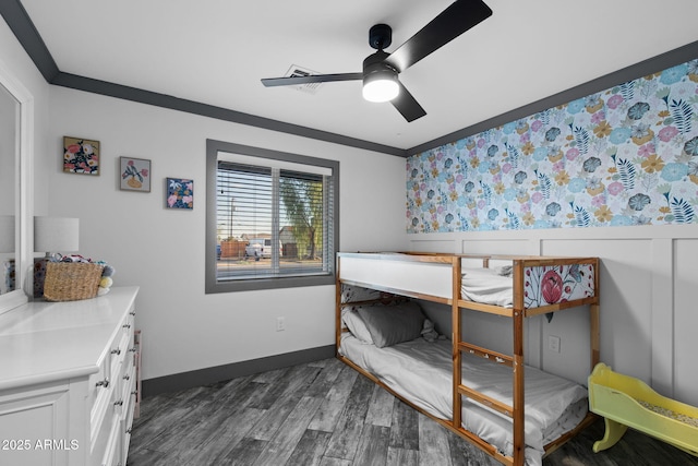bedroom with dark wood-type flooring, ceiling fan, and crown molding