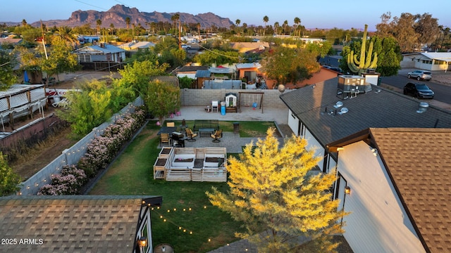 drone / aerial view featuring a residential view and a mountain view