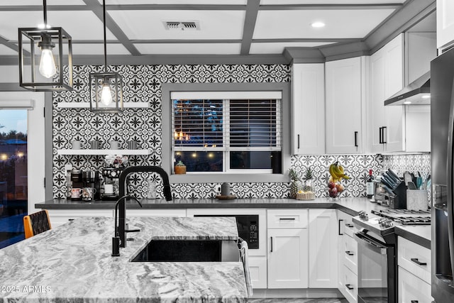 kitchen with tasteful backsplash, light stone countertops, black gas range oven, a sink, and visible vents
