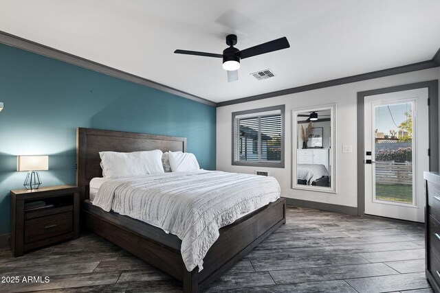 bedroom featuring dark wood finished floors, visible vents, and multiple windows