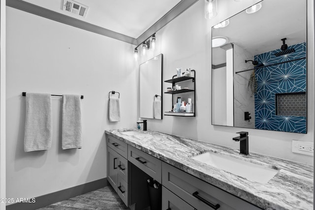 full bath with double vanity, visible vents, baseboards, and a sink