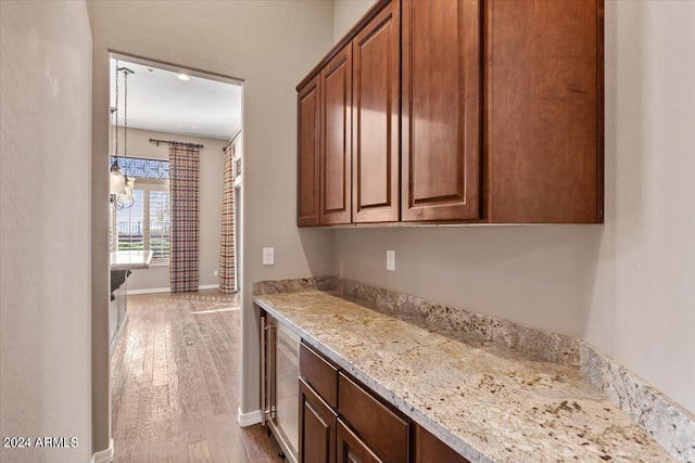 kitchen featuring hardwood / wood-style flooring and light stone countertops