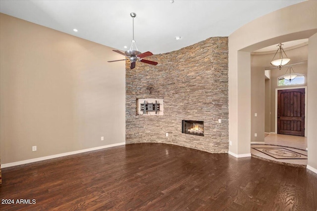 unfurnished living room featuring wood-type flooring, a fireplace, and ceiling fan