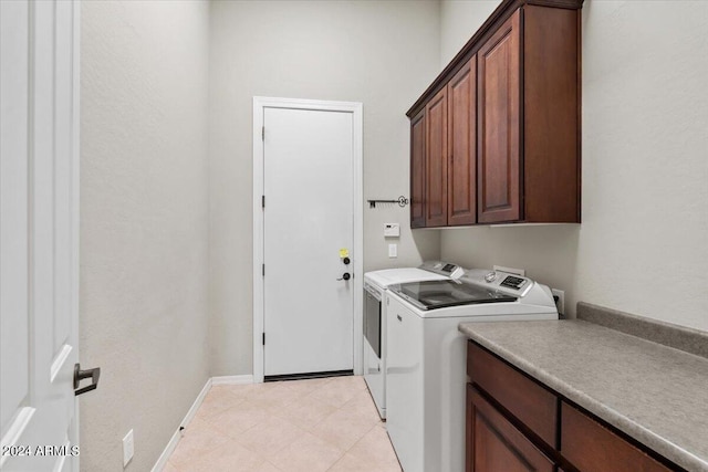 washroom featuring washer and dryer and cabinets