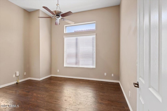 spare room with dark wood-type flooring and ceiling fan