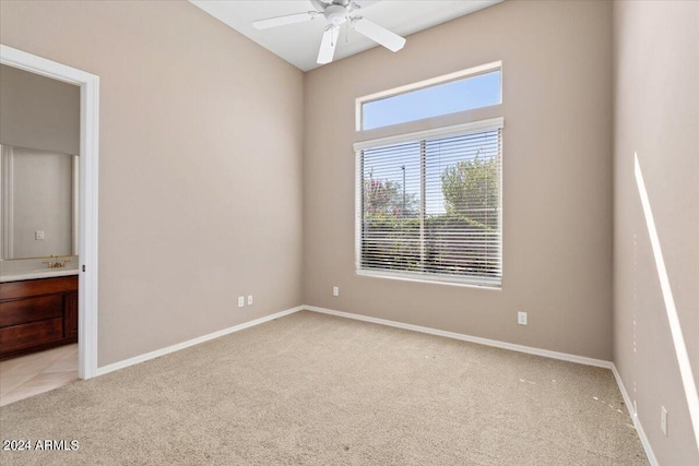 empty room featuring light colored carpet and ceiling fan