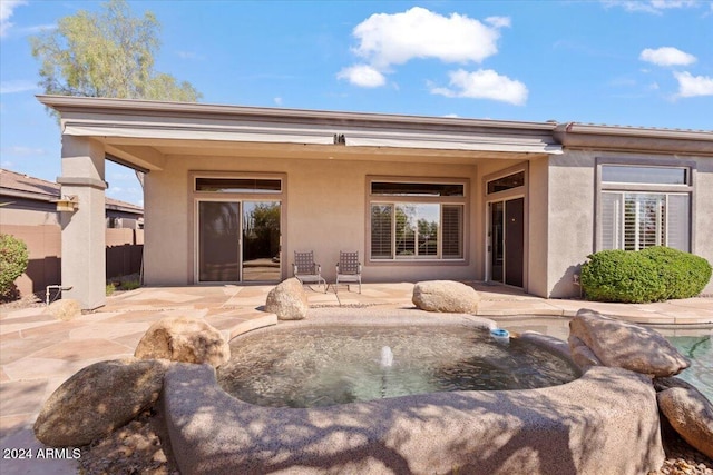 back of house with a patio