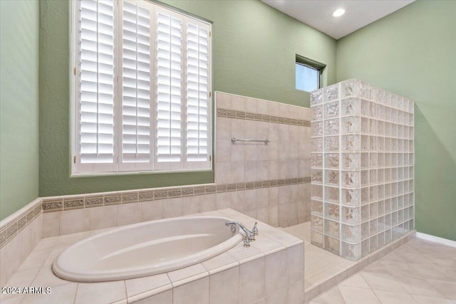 bathroom featuring tile patterned floors and separate shower and tub