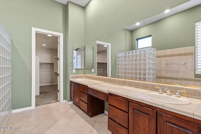 bathroom featuring vanity, tile patterned floors, and walk in shower