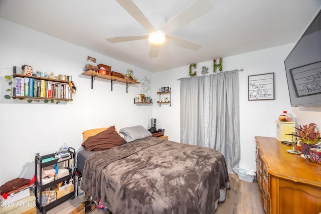 bedroom with ceiling fan and light hardwood / wood-style floors