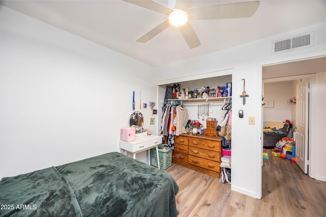 bedroom featuring ceiling fan, a closet, and hardwood / wood-style floors