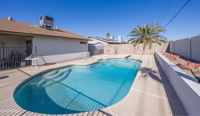 view of pool with a diving board and central AC