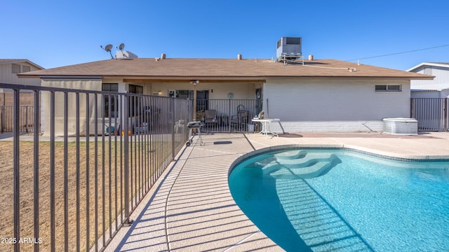 view of swimming pool featuring central AC and a patio