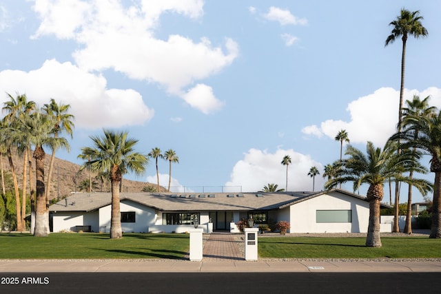 ranch-style home featuring a front yard