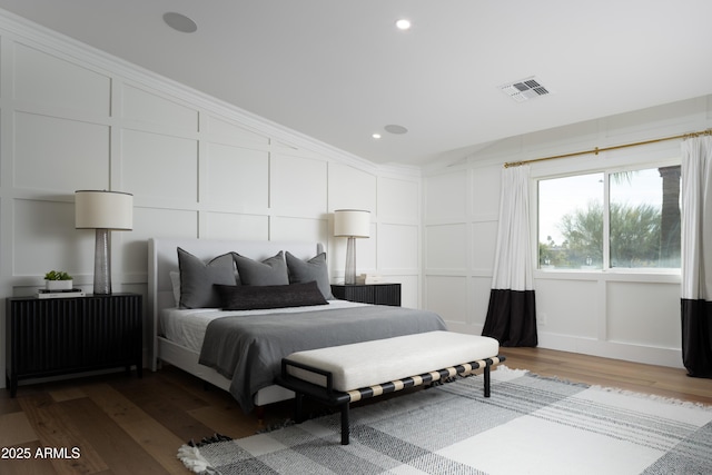 bedroom featuring hardwood / wood-style flooring, ornamental molding, and lofted ceiling