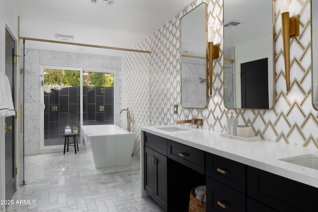 bathroom featuring vanity and a bath