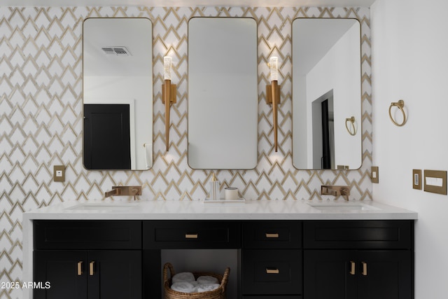 bathroom with vanity and tasteful backsplash