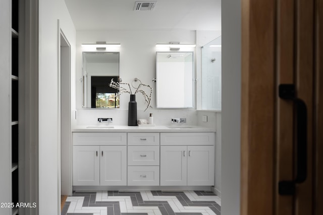 bathroom featuring vanity and a shower with door