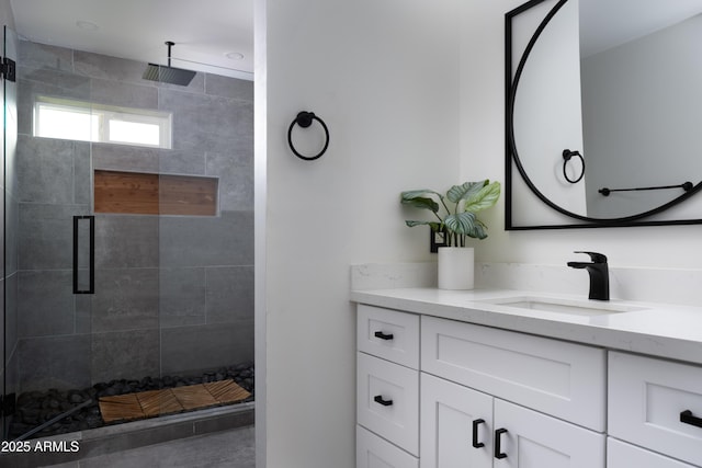 bathroom featuring vanity and a shower with door