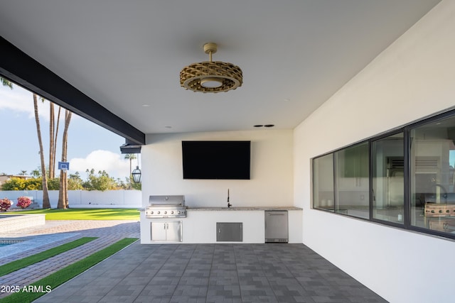 view of patio with grilling area and an outdoor kitchen