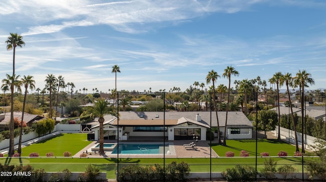 exterior space with a fenced in pool and a patio area