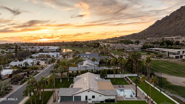 aerial view at dusk featuring a mountain view