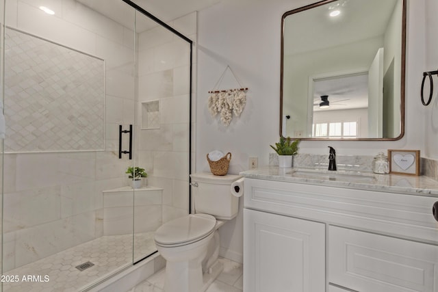 bathroom with vanity, walk in shower, ceiling fan, and toilet