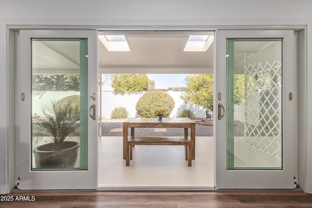 entryway featuring a skylight and hardwood / wood-style floors