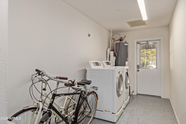 laundry room featuring water heater and separate washer and dryer