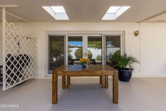 interior space featuring french doors and concrete flooring