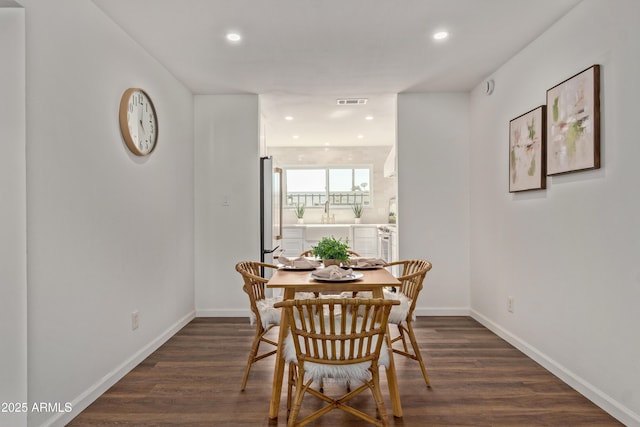 dining space featuring dark wood-type flooring